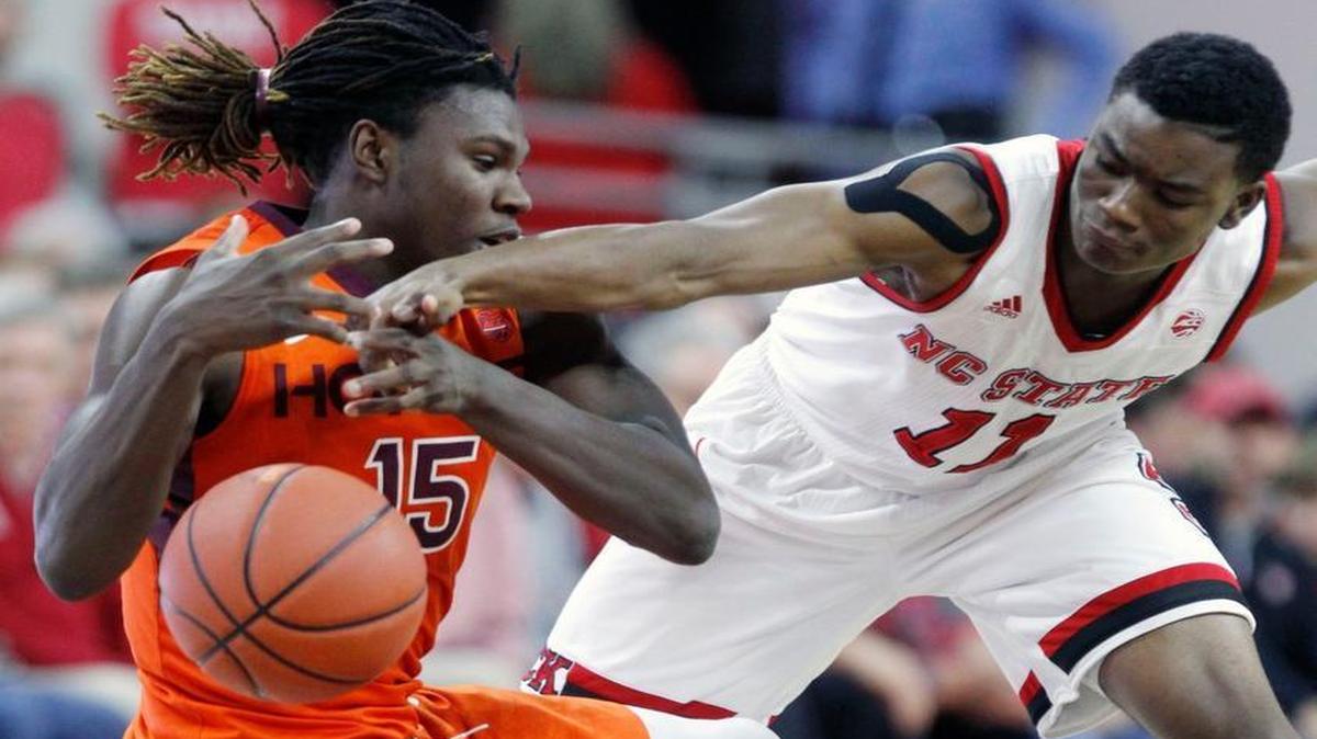 N.C. State's Markell Johnson (11), right, steals the ball from Virginia Tech's Chris Clarke (15) as Clarke falls on N.C. State's Dennis Smith Jr. (4) during the second half of N.C. State's 104-78 victory over Virginia Tech at PNC Arena in Raleigh, N.C., Wednesday, January 4, 2017.