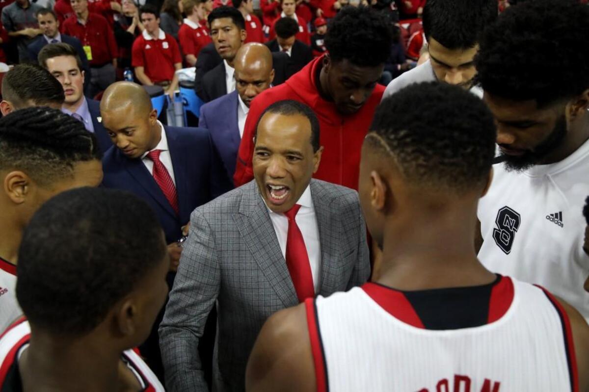 N.C. State's head coach Kevin Keatts huddles with his team prior to the season opener against VMI at PNC Arena in Raleigh, N.C., Friday, Nov. 10, 2017.