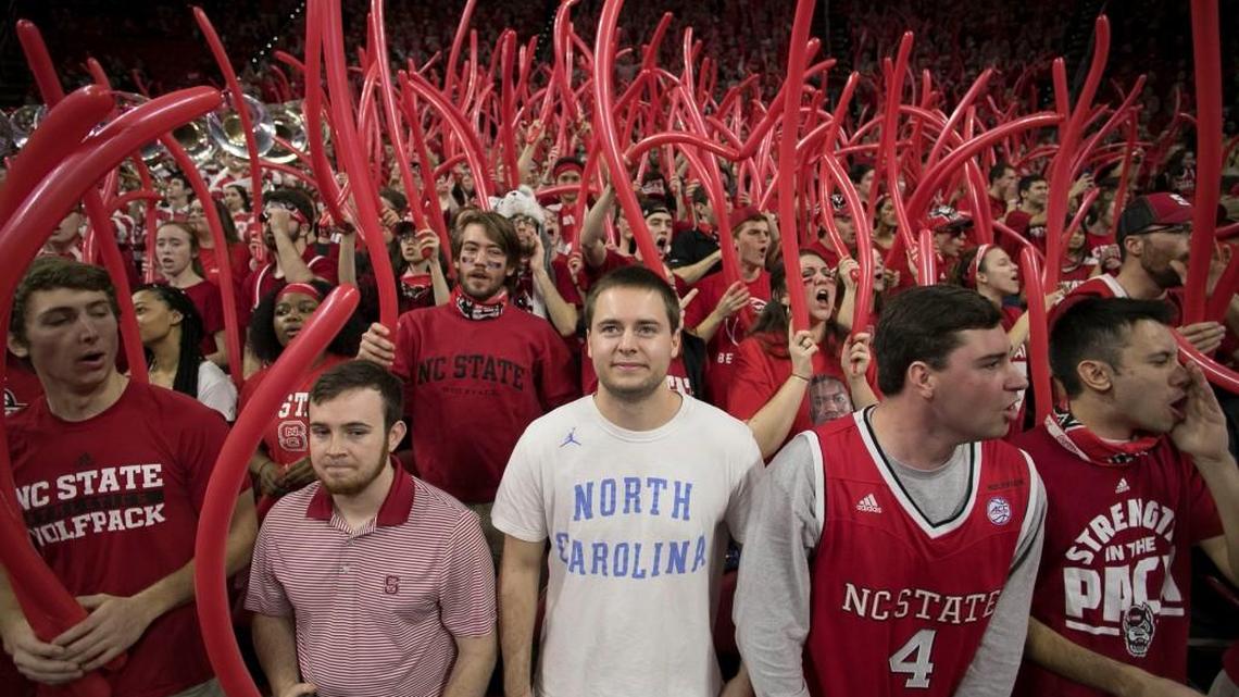 N.C. State junior Casey Davison of Raleigh, shows his support for the Tar Heels in a sea of red, prior to the tip-off of the game on Saturday, February 10, 2018 at the PNC Arena in Raleigh, N.C.