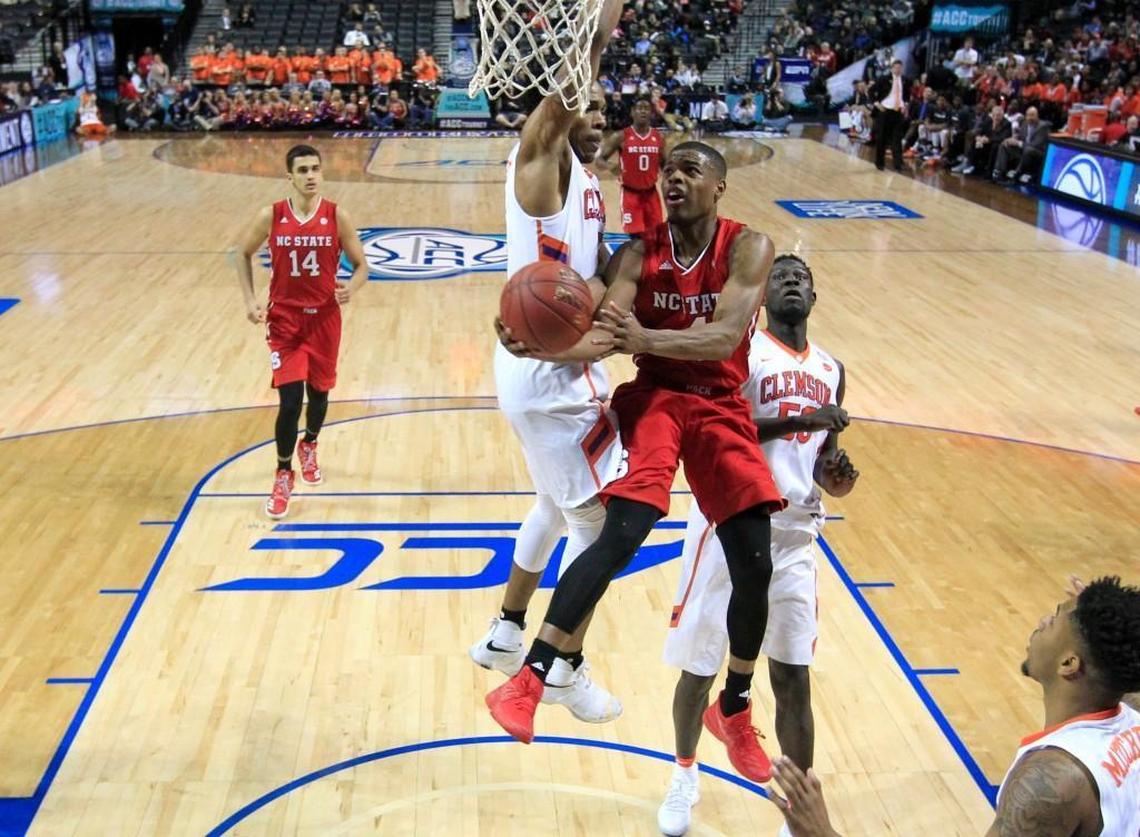 N.C. State’s Dennis Smith Jr. drives to the basket past Clemson’s Jaron Blossomgame (5) and Sidy Djitte (50) during the 2017 ACC tournament.