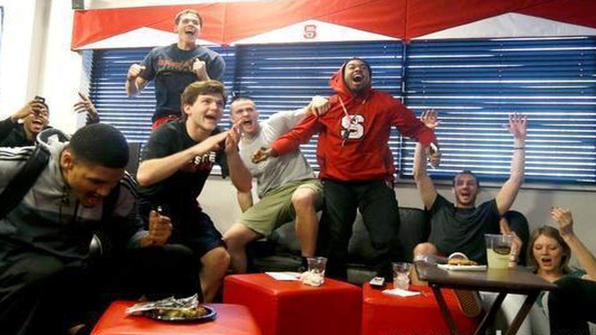 
From left, N.C. State's Ralston Turner, Terry Henderson, Kyle Washington, Staats Battle, Chris Corchiani Jr., Patrick Wallace, Trevor Lacey and Chase Cannon celebrate as they learn that the Wolfpack is a number eight seed in the East Region as members of the N.C. State Wolfpack basketball team watch the NCAA Tournament selection show at the Dail Basketball Center in Raleigh, N.C., Sunday, March 15, 2015.
