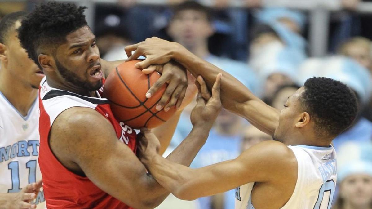 N.C. State's Lennard Freeman (1) keeps the rebound from North Carolina's Nate Britt (0) during the Wolfpack’s game against UNC at the Smith Center in Chapel Hill Saturday, January 16, 2016.