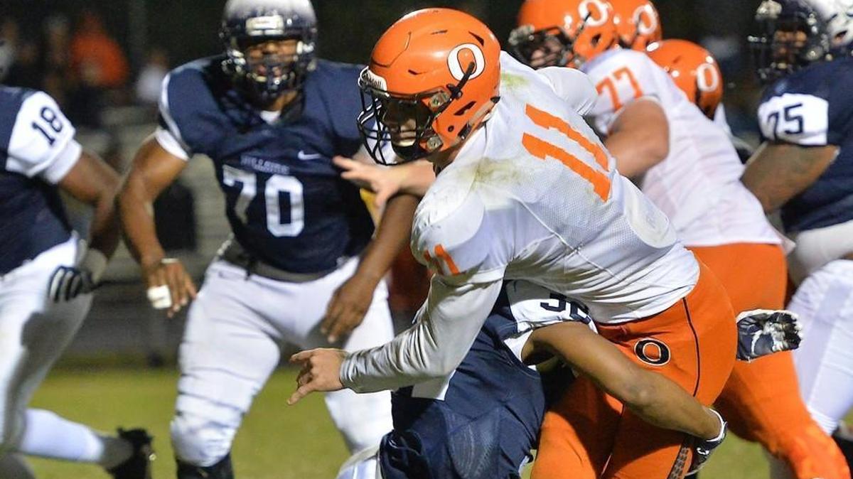 Payton Wilson, middle in white and orange, got a visit from NC State coach Dave Doeren on Thursday.