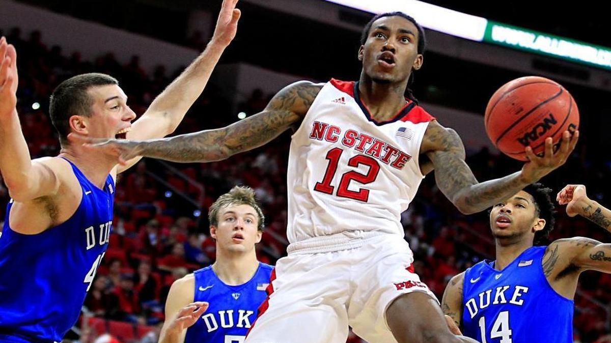 N.C. State's Cat Barber (12) drives to the basket past Duke's Marshall Plumlee (40) during the second half of Duke's 88-78 victory over N.C. State at PNC Arena on Jan. 23.