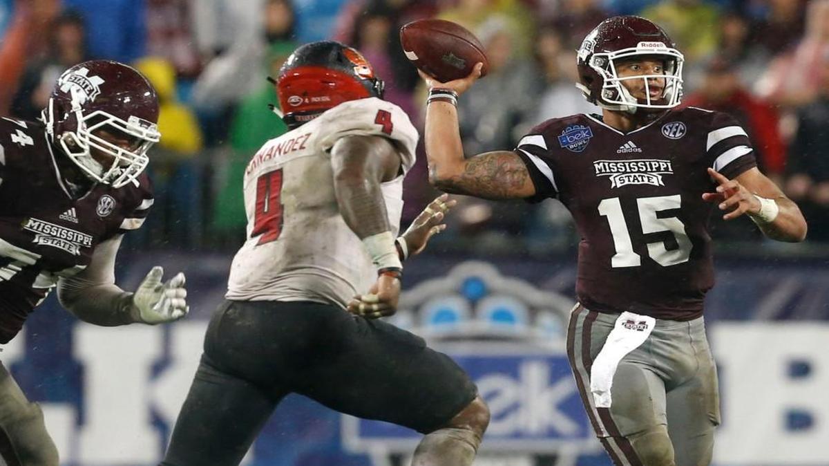 Mississippi State quarterback Dak Prescott (15) pass while N.C. State linebacker Jerod Fernandez (4) pressures him during the second half of Mississippi State's 51-28 victory over N.C. State in the Belk Bowl at Bank of America Stadium in Charlotte, N.C., Wednesday, December 30, 2015.
