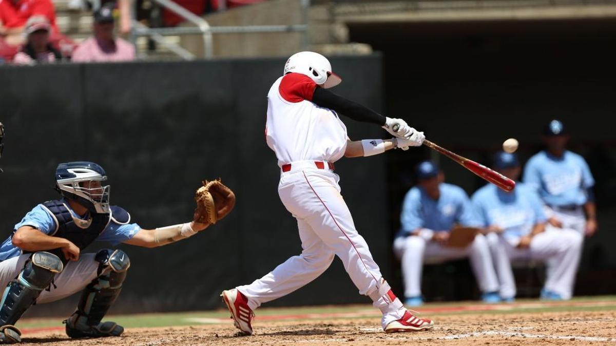 N.C. State first baseman Preston Palmeiro (12) makes contact with the ball for a home run that also brought N.C. State's Evan Mendoza (18) home for a total of two runs during the Wolfpack's 10-1 win over North Carolina on Saturday, May 21, 2016 at Doak Field in Raleigh.