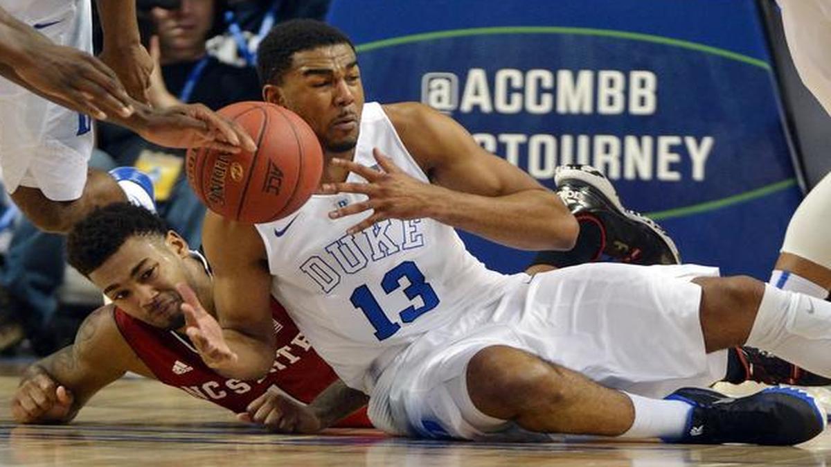 
Duke’s Matt Jones (13) steals the ball from N.C. State’s Trevor Lacey during first-half action in the quarterfinal round of the Atlantic Coast Conference basketball tournament at the Greensboro Coliseum.
