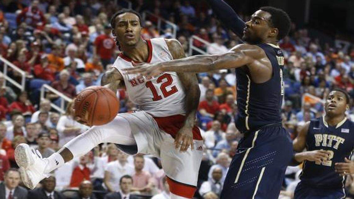 
N.C. State’s Cat Barber (12) passes around Pitt’s Michael Young (2) during the second half of N.C. State’s 81-70 victory over Pittsburgh on Wednesday in the second round of the 2015 New York Life ACC Tournament at the Greensboro Coliseum in Greensboro.
