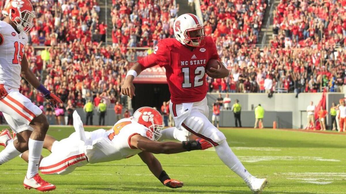 N.C. State quarterback Jacoby Brissett (12) beats Clemson's B.J. Goodson (44) to score on a 13-yard touchdown run during the first half of the Wolfpack's game against Clemson at Carter-Finley Stadium in on Oct. 31, 2015.