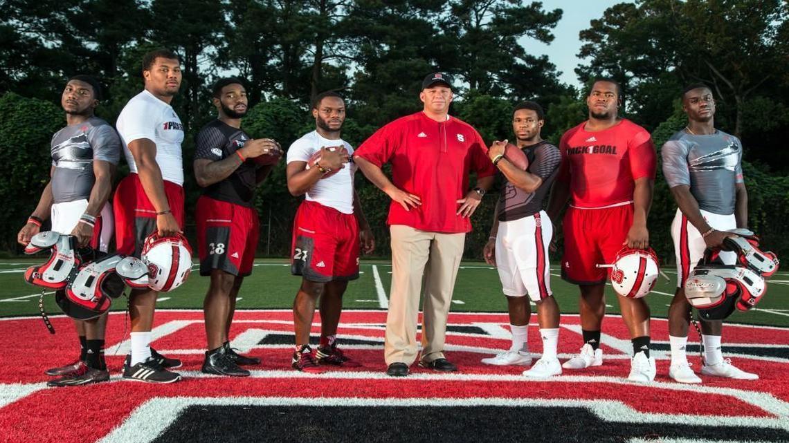 N.C. State football players, from left, Shawn Boone, Bradley Chubb, Jaylen Samuels, Matt Dayes, Coach Dave Doeren, Nyheim Hines, B.J. Hill and Jack Tocho.