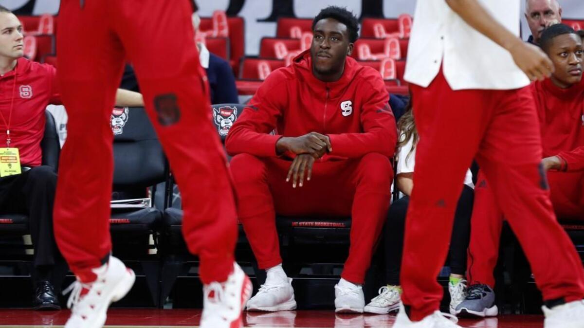 N.C. State's Abdul-Malik Abu watches the team warm up before the Wolfpack's game against Penn State at PNC Arena in Raleigh, N.C., Wednesday, Nov. 29, 2017.