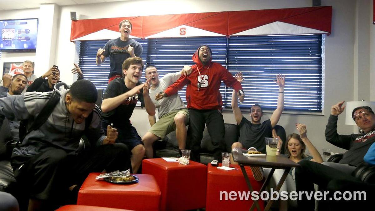 From left, N.C. State's Ralston Turner, Terry Henderson, Kyle Washington, Staats Battle, Chris Corchiani Jr., Patrick Wallace, Trevor Lacey, Chase Cannon and Mark Gottfried celebrate as they learn that the Wolfpack is a number eight seed in the east while watching the NCAA Tournament selection show at the Dail Basketball Center March 15, 2015.
