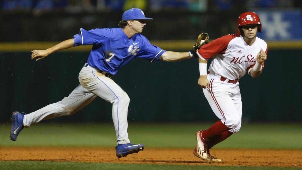 Connor Heady of the Kentucky Wildcats tags out Will Wilson of the NC State Wolfpack during a run down.