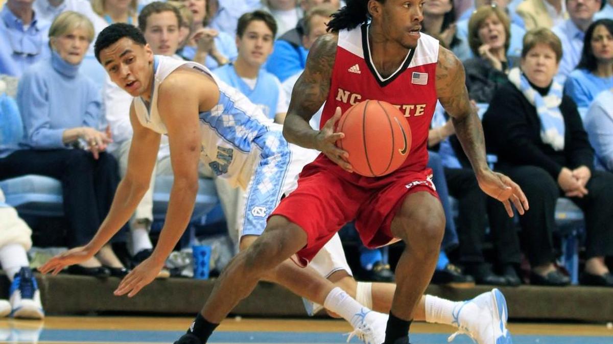 N.C. State's Cat Barber (12) keeps the ball from North Carolina’s Marcus Paige (5) during the first half of N.C. State's game against UNC at the Smith Center in Chapel Hill, N.C., Saturday, January 16, 2016.