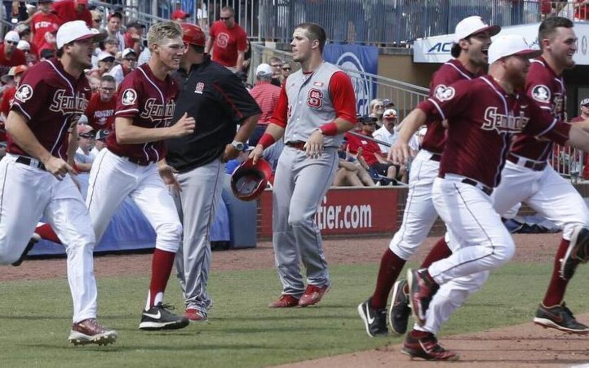 
N.C. State's Chance Shepard (24) heads back to the dugout as Florida State players rush the field after Florida State's 6-2 victory over N.C. State in the ACC Baseball Championship at the Durham Bulls Athletic Park in Durham, N.C., Sunday, May 24, 2015.
