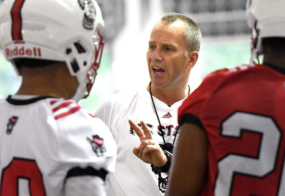 NC State head coach Dave Doeren speaks with players during the first day of practice at the Wolfpack’s indoor practice facility in Raleigh, N.C. Friday, August 3, 2018.