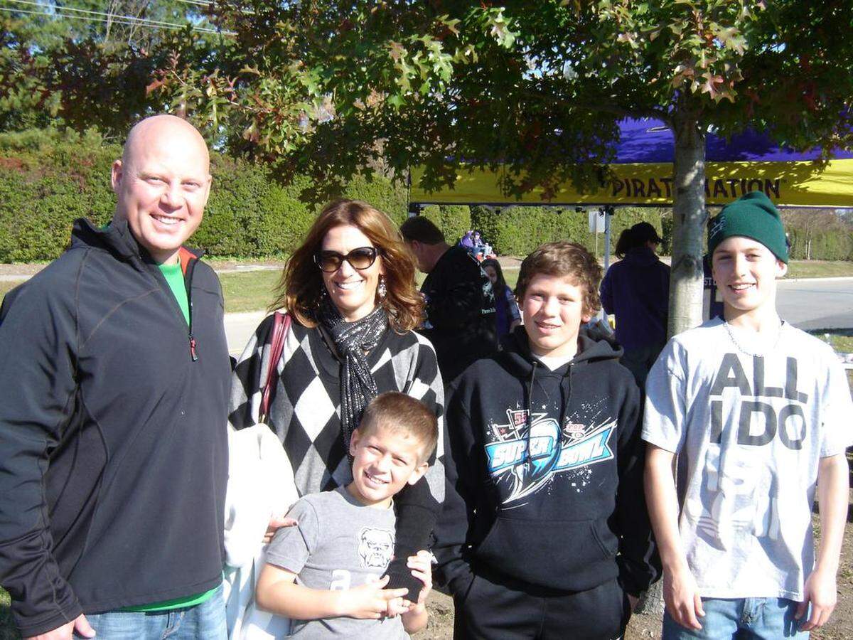 The Thomas family before a Marshall-East Carolina football game in 2012: Trevor (left), Shelly, Drake, Thayer and Lex (with Shelly). Trevor helped Marshall win a national tile in 1992. Drake, a senior in high school, is one of N.C. State’s top recruits. Thayer, a freshman receiver, has been N.C. State’s breakout star this season.