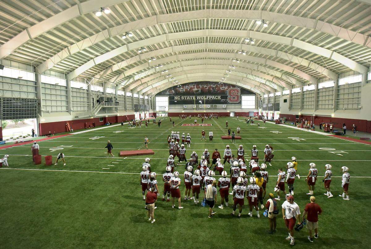 The NC State football team go through drills during the first day of practice at the Wolfpack’s indoor practice facility in Raleigh, N.C. Friday, August 3, 2018.