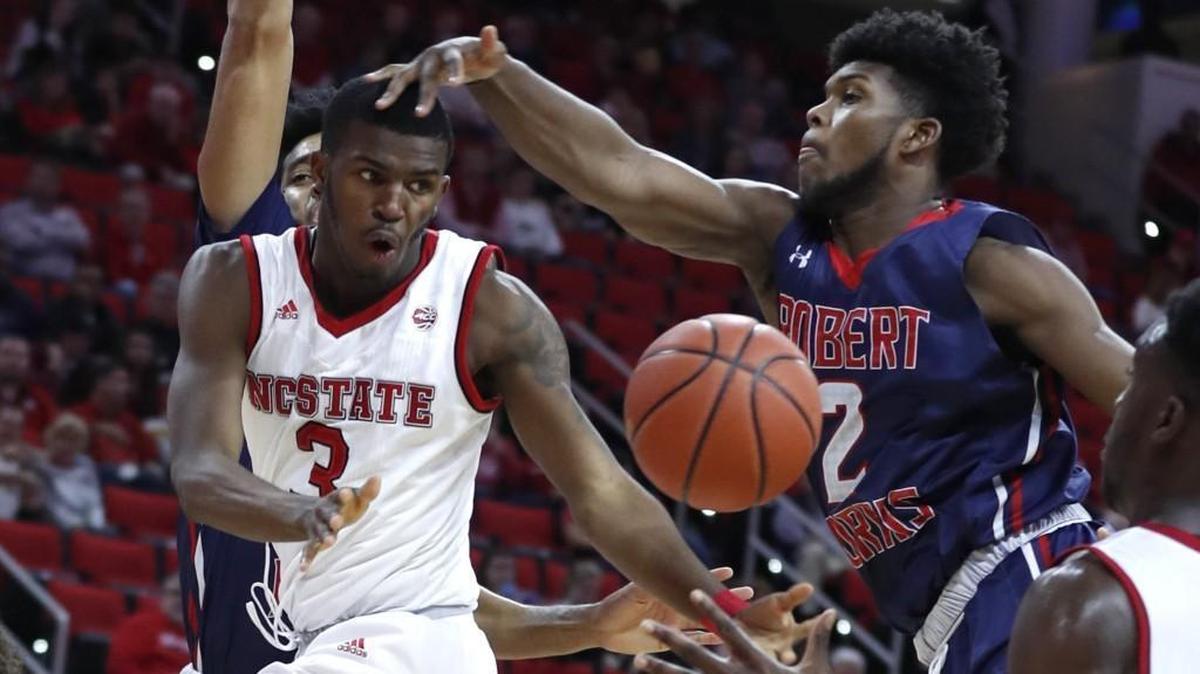N.C. State's Lavar Batts Jr. (3) passes the ball to Abdul-Malik Abu (0) as Robert Morris forward David Cole (2) defends during the first half of the Wolfpack’s game against Robert Morris at PNC Arena in Raleigh on Tuesday, Dec. 19, 2017.