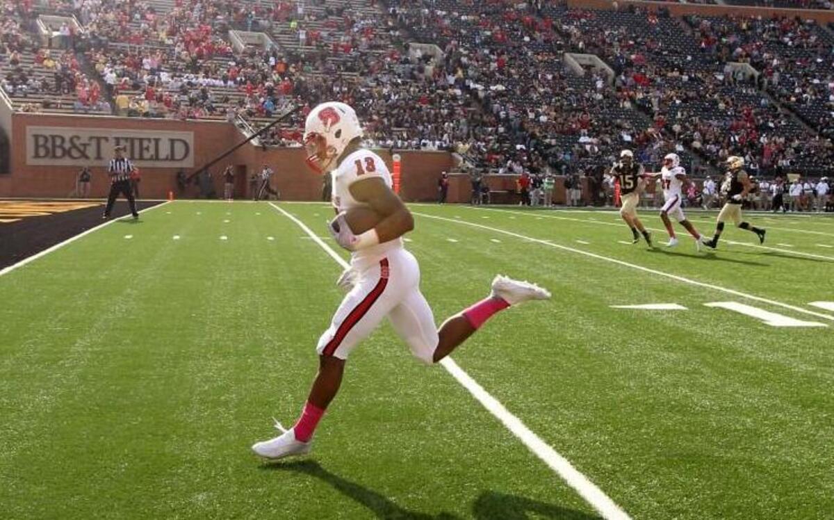 N.C. State's Bra'Lon Cherry (13) scores on a 52-yard punt return during the second half of N.C. State's 35-17 victory over Wake Forest at BB&T Field in Winston-Salem Saturday, Oct. 24, 2015.