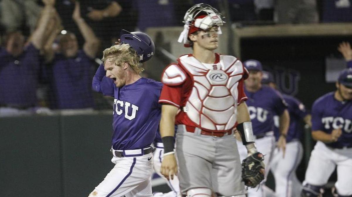 
TCU's Evan Williams scores the winning run off a single by teammate Elliott Barzilli as N.C. State catcher Andrew Knizner (11) walks off in the tenth inning at the Fort Worth Regional of the NCAA college baseball tournament. TCU won 9-8. 
