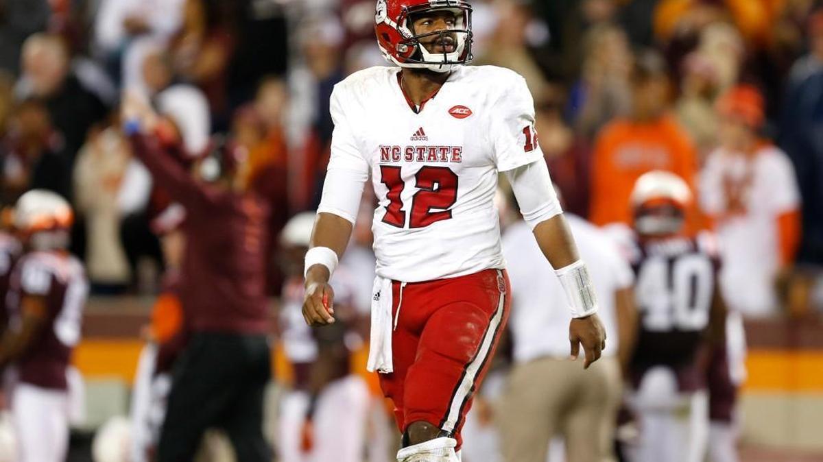 
N.C. State quarterback Jacoby Brissett (12) walks off the field after throwing an interception during the second half of Virginia Tech's 28-13 victory over N.C. State at Lane Stadium in Blacksburg, Va. Friday, Oct. 9, 2015.
