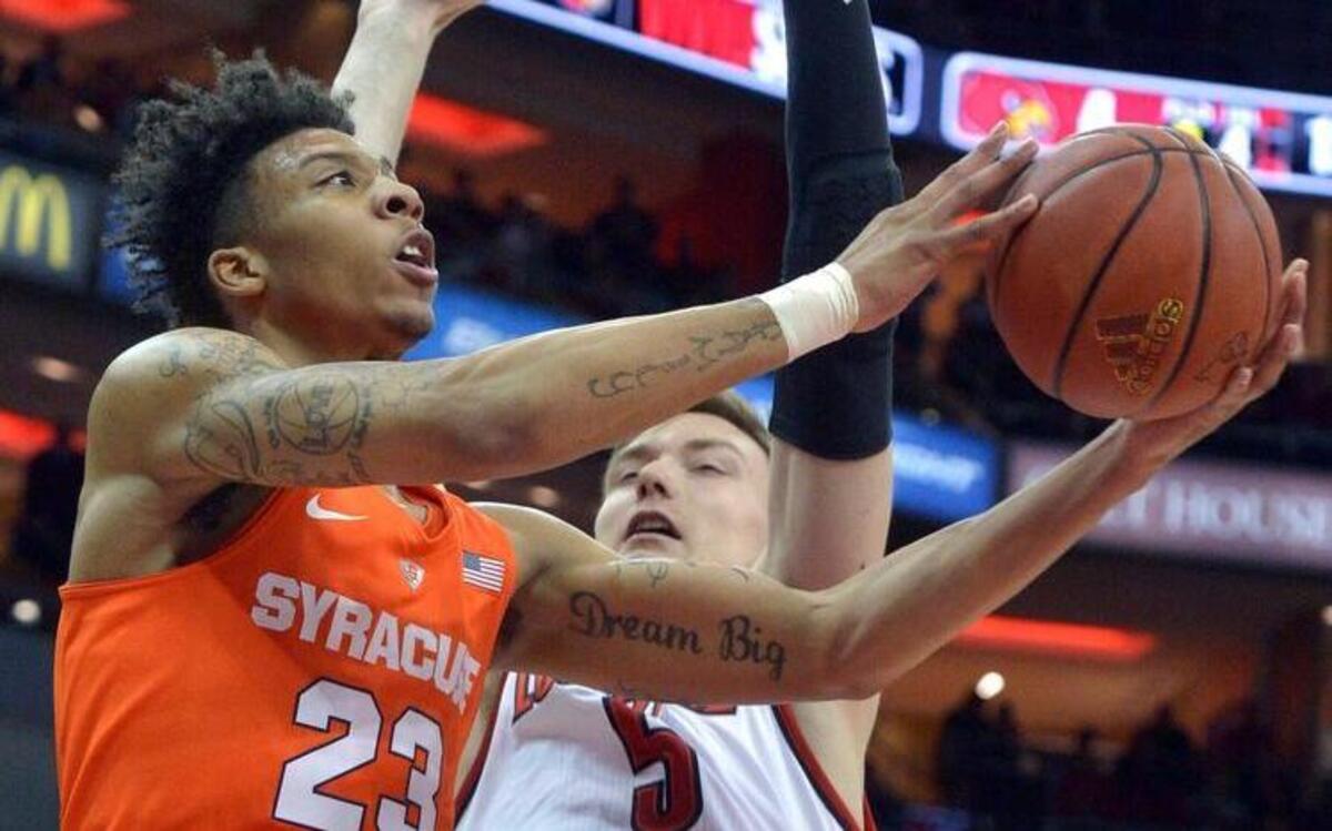 Syracuse's Malachi Richardson (23) attempts a layup around the defense of Louisville's Matz Stockman (5) during the first half of an NCAA college basketball game, Monday, Feb. 17, 2016, in Louisville Ky.
