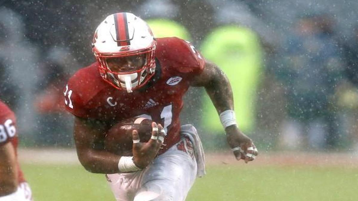 N.C. State running back Matt Dayes (21) runs upfield after escaping from Notre Dame linebacker Asmar Bilal (22), right, during the Wolfpack’s victory over Notre Dame at Carter-Finley Stadium in Raleigh Saturday, Oct. 8, 2016.