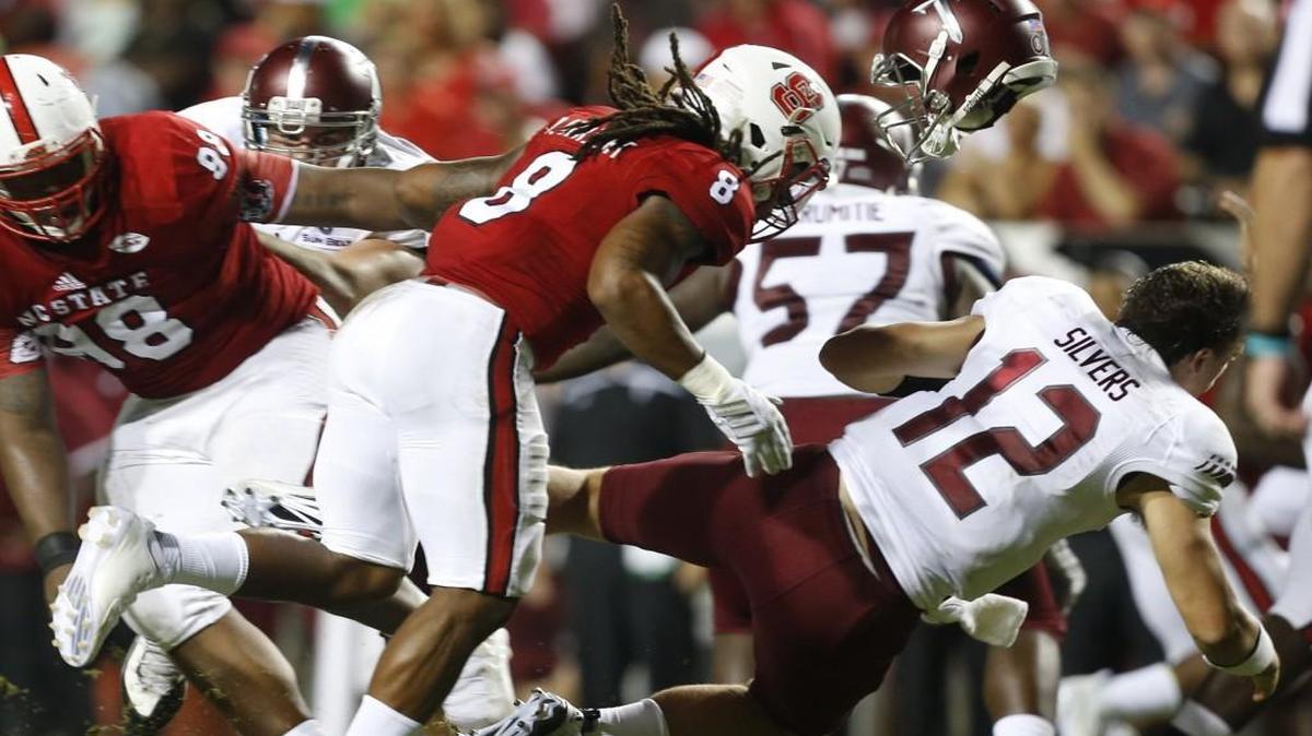 
N.C. State defensive back Dravious Wright (8) hits Troy quarterback Brandon Silvers (12), causing him to fumble, one of five turnovers the Wolfpack caused earlier in the season.
