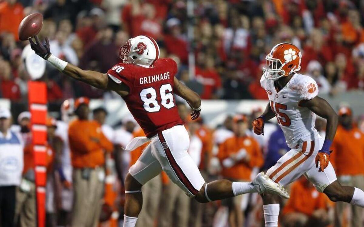 N.C. State tight end David J. Grinnage, left, deflects the ball and then makes the catch while defended by Clemson safety T.J. Green on Oct. 31. The Tigers won 56-41. Grinnage finished the game with seven catches for 82 yards and a touchdown.