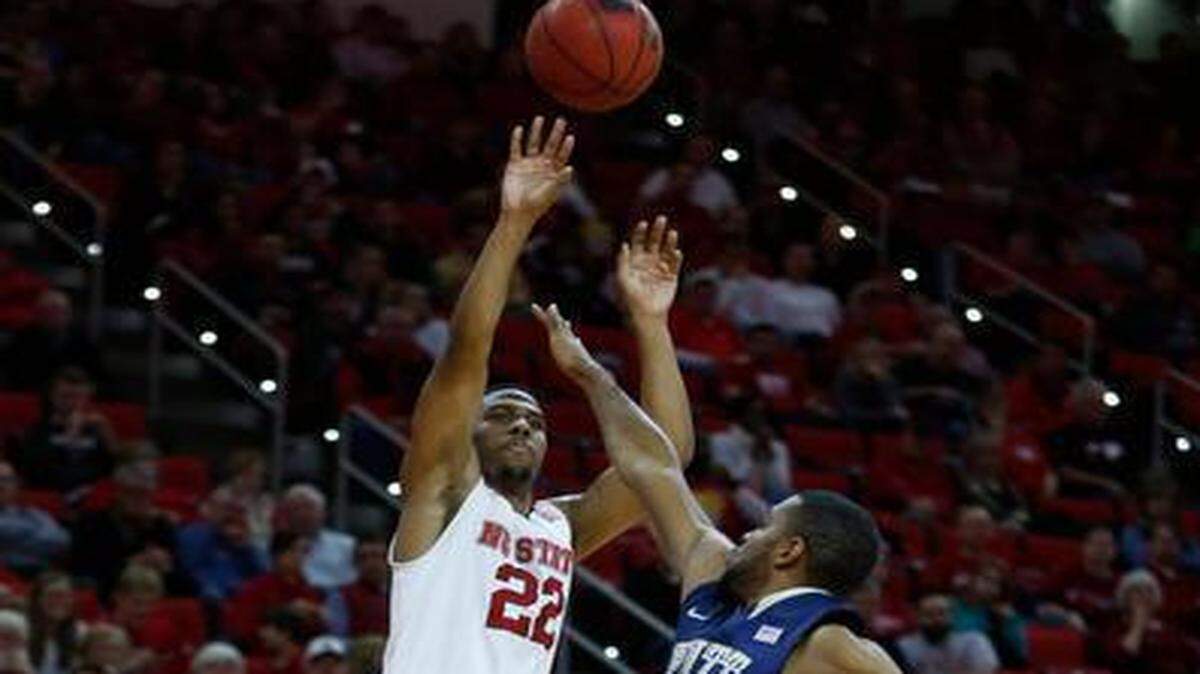 
N.C. State’s Ralston Turner (22) drills a 3-pointer as Pittsburgh’s Sheldon Jeter defends during the second half of the Wolfpack’s 68-50 victory at PNC Arena in Raleigh on Jan. 3.
