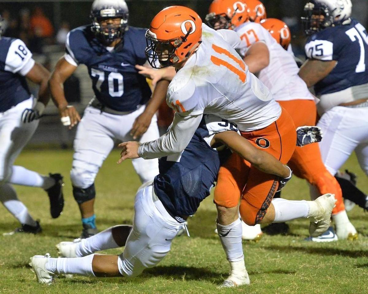 Hillside’s Brendon Edgerton (32) tackles Orange’s Payton Wilson (11) during the fourth quarter.The Orange Panthers visited the Hillside Hornets in a high school football game on Oct. 13, 2017.
