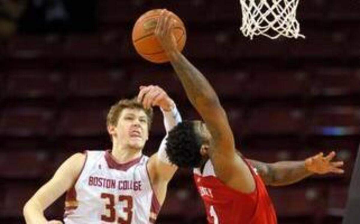 
Boston College Eagles guard Patrick Heckmann (33) blocks the shot of North Carolina State Wolfpack guard Trevor Lacey (1) during the second half at Silvio O. Conte Forum. Mandatory Credit: Bob DeChiara-USA TODAY Sports
