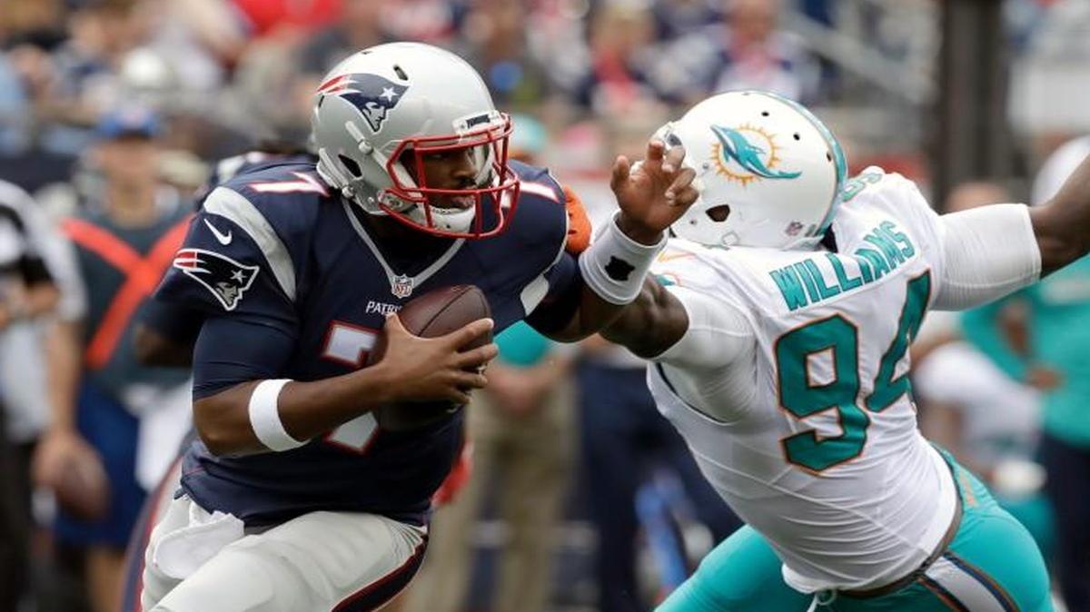 Former N.C. State and current New England Patriots quarterback Jacoby Brissett scrambles away from Miami Dolphins defensive end Mario Williams during the second half of an NFL football game Sunday, Sept. 18, 2016, in Foxborough, Mass. Brissett led the Patriots to a 31-24 victory over the Miami Dolphins after taking over from injured starting quarterback Jimmy Garoppolo in the second quarter.
