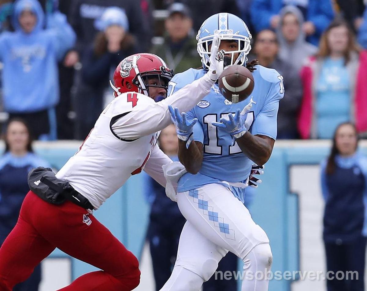 N.C. State cornerback Nick McCloud (4) breaks up the pass intended for North Carolina wide receiver Anthony Ratliff-Williams (17) during the first half of N.C. State’s game against UNC at Kenan Stadium in Chapel Hill, N.C., Saturday, Nov. 24, 2018.
