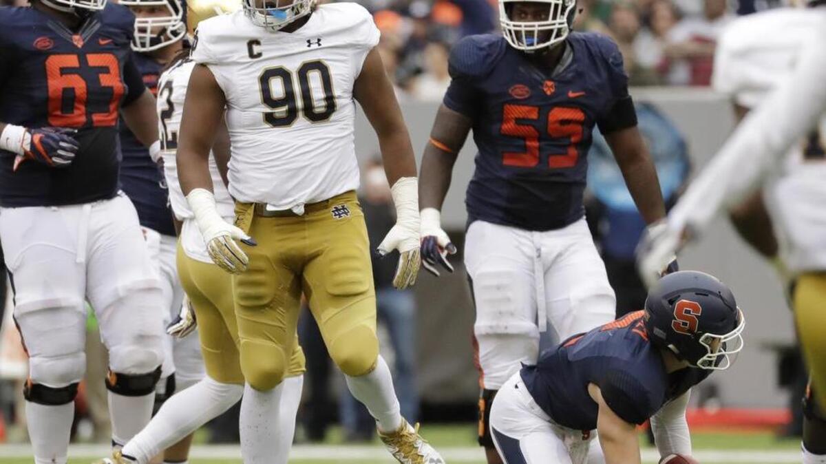 Notre Dame defensive lineman Isaac Rochell (90) walks away after sacking Syracuse quarterback Eric Dungey (2) Saturday at MetLife Stadium in East Rutherford, N.J. (AP Photo/Julio Cortez, File)