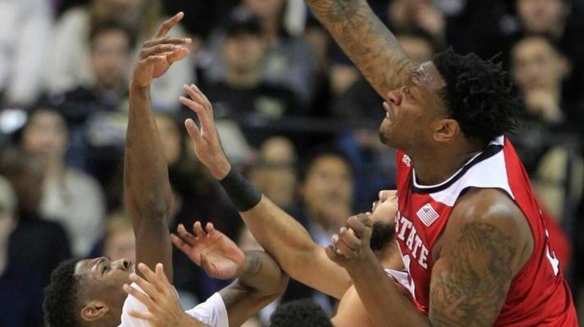 N.C. State's BeeJay Anya (21) blocks the shot by Wake Forest's Cornelius Hudson (25) during the first half of the Wolfpack's game against Wake Forest at Lawrence Joel Coliseum in Winston-Salem Sunday, January 10, 2016.
