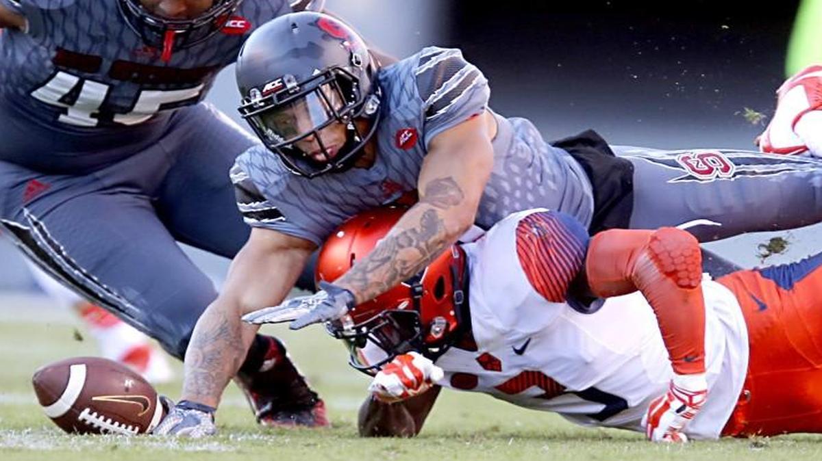 N.C. State's Josh Jones (2) goes over Syracuse's Ervin Philips (3) to recover the fumble by Philips during the Wolfpack’s victory over Syracuse at Carter-Finley Stadium in Raleigh on Nov. 21, 2015.