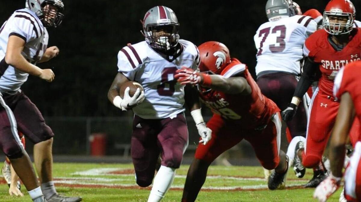 Wakefield’s Chad Norfleet, middle, is tackled by Sanderson’s Alim McNeill in 2016.