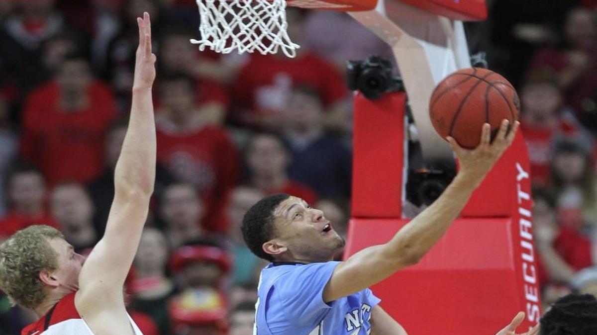 North Carolina’s Justin Jackson, middle, scores as N.C. State’s Maverick Rowan, left, defends during the second half of UNC’s 80-68 win over the Wolfpack Wednesday. Jackson finished the game with 17 points and six rebounds.