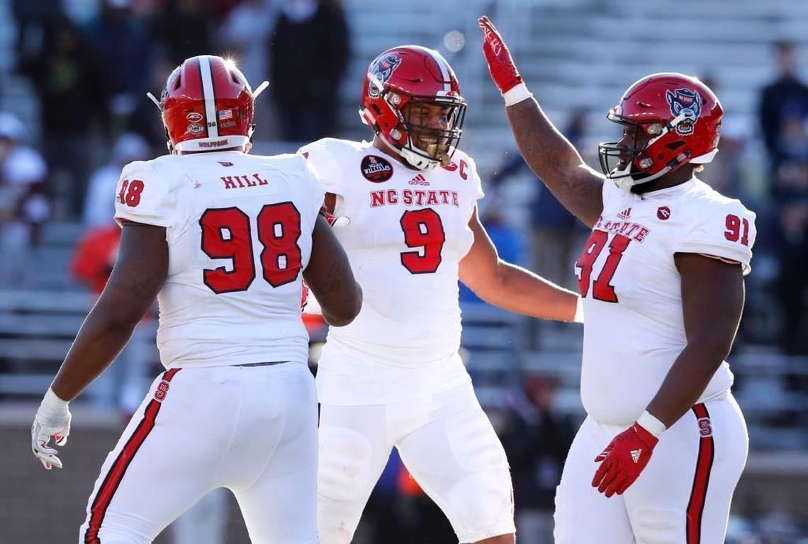 N.C. State defensive end Bradley Chubb (9) celebrates with B.J. Hill (98) and Eurndraus Bryant (91) after sacking Boston College's quarterback Darius Wade (4) during the second half of N.C. State's 17-14 victory over Boston College at Alumni Stadium in Chestnut Hill, MA, on Nov. 11, 2017.