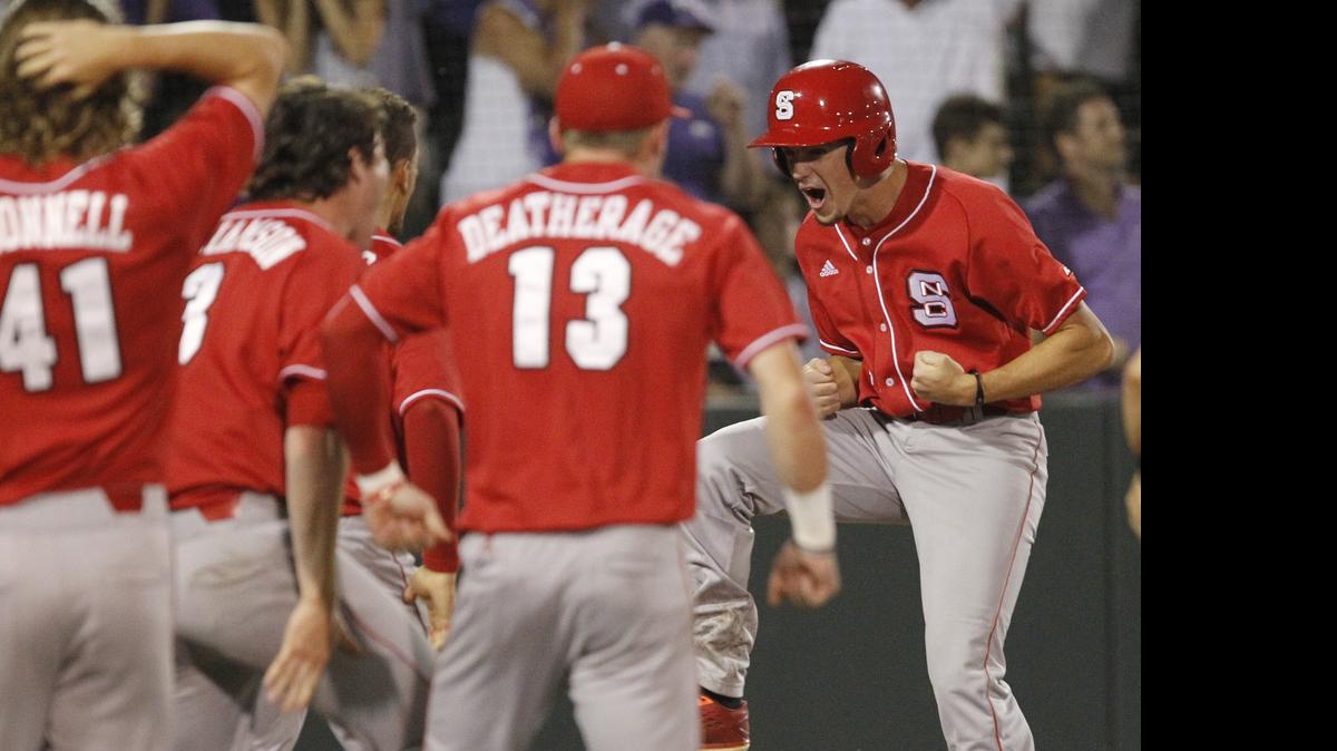 
N.C. State's Tommy DeJuneas, right, is greeted at home plate by teammates after scoring the tying run against TCU on a two-run home run hit by designated hitter Chance Shepard in the ninth inning at the Fort Worth Regional of the NCAA college baseball tournament.
