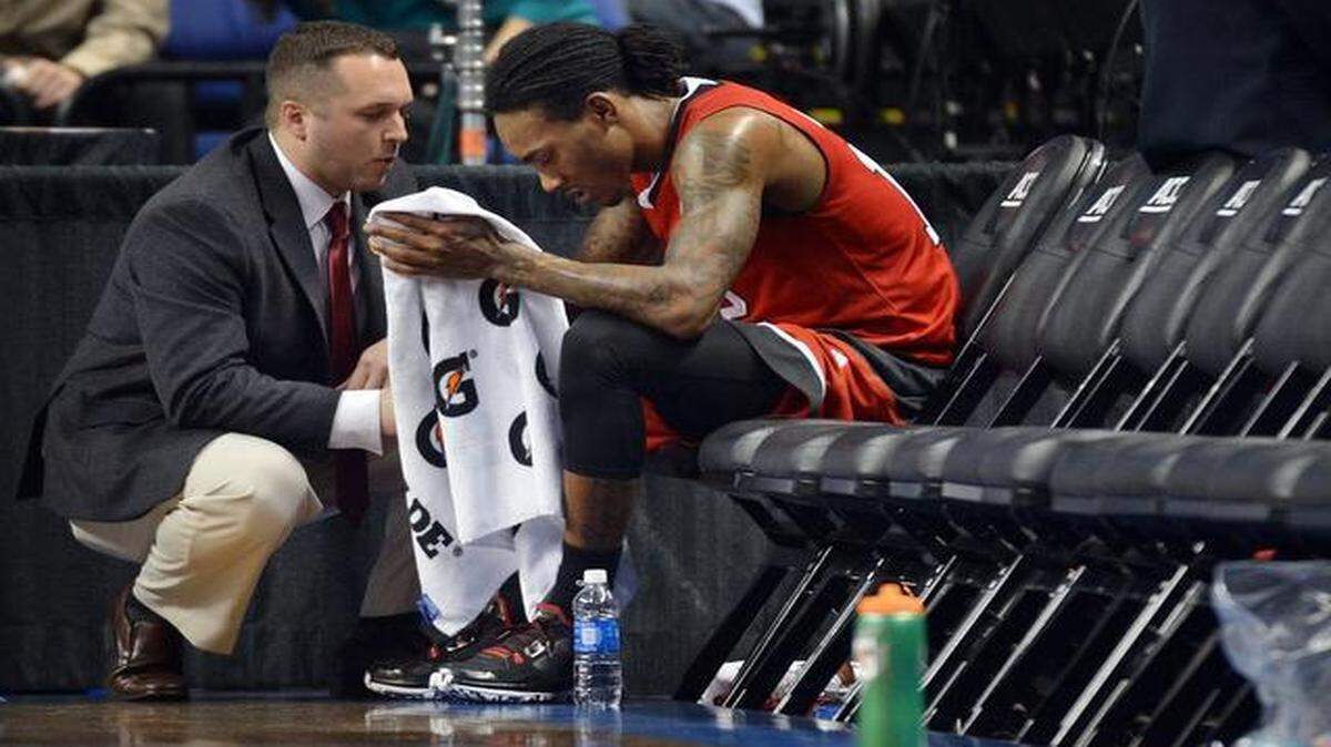 
N.C. State trainer Ryam Holleman tends to guard Cat Barber (12) after he collided with Duke forward Amile Jefferson (21) in the second half of play. Duke defeated N.C. State 77-53 in the quarter-final round of the Atlantic Coast Conference basketball tournament at the Greensboro Coliseum in Greensboro, N.C. Thursday, March 12, 2015.
