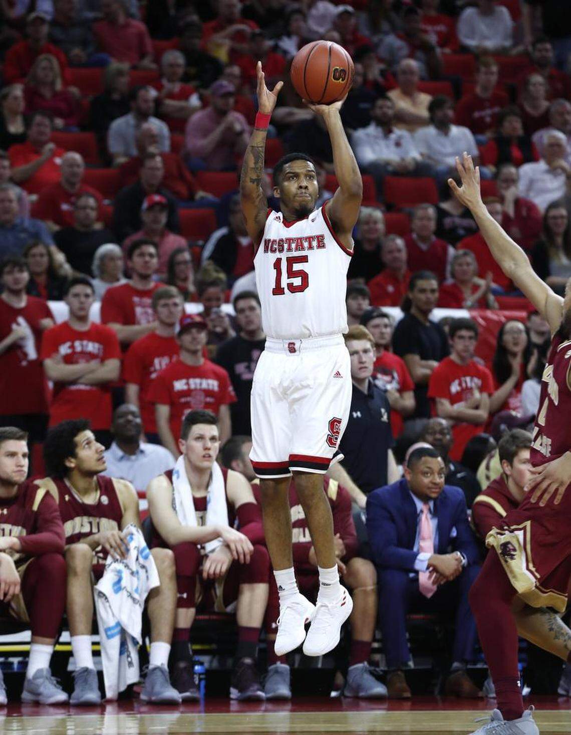 N.C. State's Sam Hunt (15) makes a three-pointer during the first half of N.C. State's game against Boston College at PNC Arena on Feb. 20, 2018.