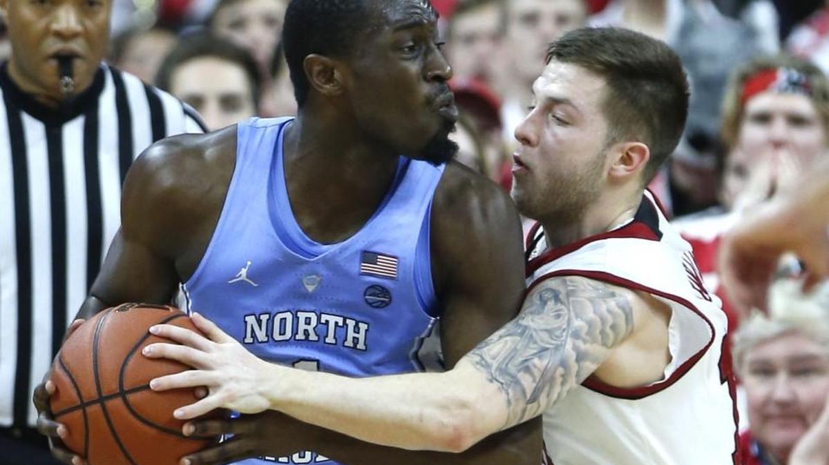 N.C. State's Braxton Beverly, right, has a depiction of Christ carrying the cross tattoed on his left bicep. Here he pressures North Carolina's Theo Pinson during the game at PNC Arena in Raleigh, N.C., Saturday, Feb. 10, 2018.