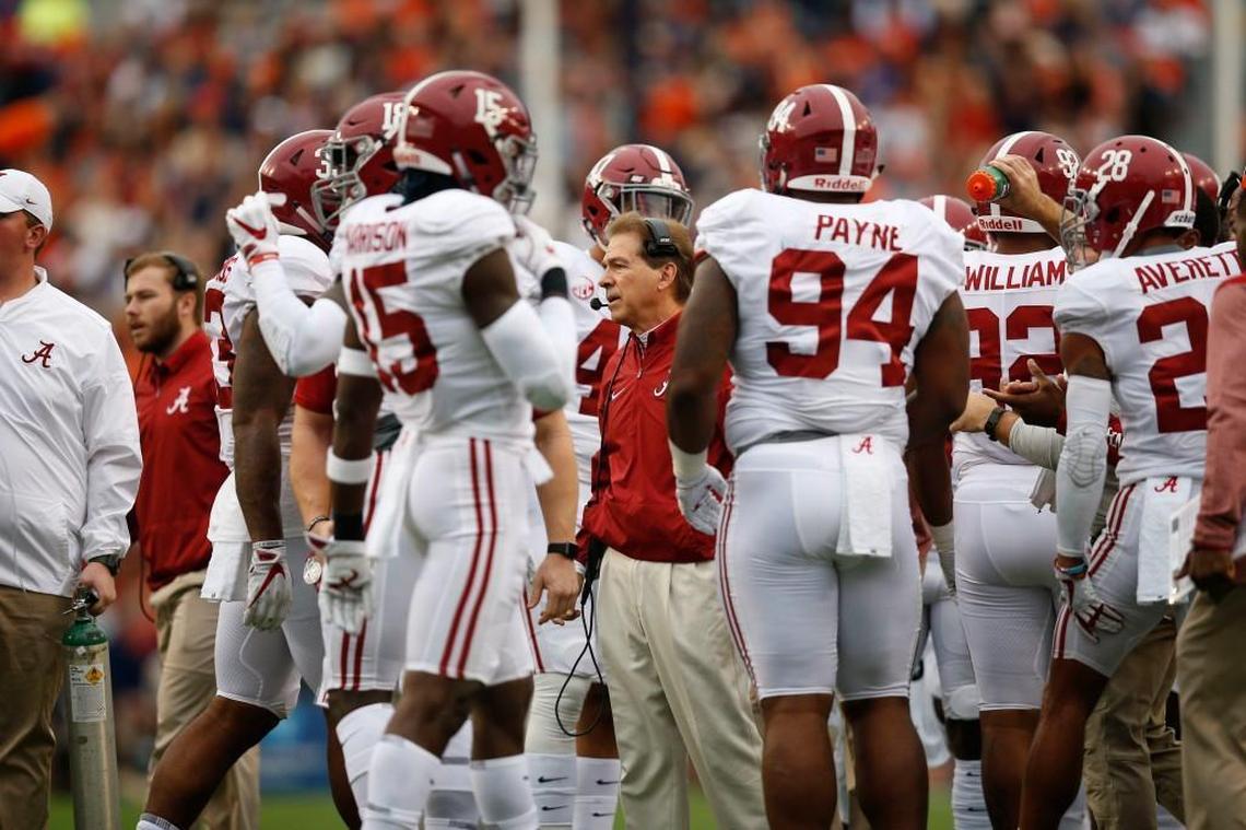 Alabama coach Nick Saban, middle, makes $11.1 million a year, which is more than any other coach in college football.