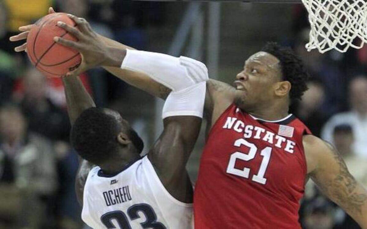 
N.C. State's BeeJay Anya (21) stops the shot by Villanova's Daniel Ochefu (23) during the first half in the third round NCAA Division I Men's Basketball Tournament at the Consol Energy Center in Pittsburgh.
