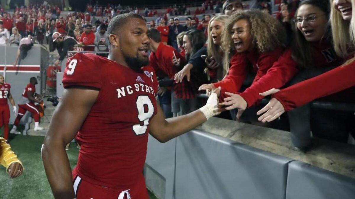 N.C. State defensive end Bradley Chubb (9) greets fans as he walks off the field after N.C. State's 33-21 victory over UNC at Carter-Finley Stadium in Raleigh, N.C., Saturday, Nov. 25, 2017.