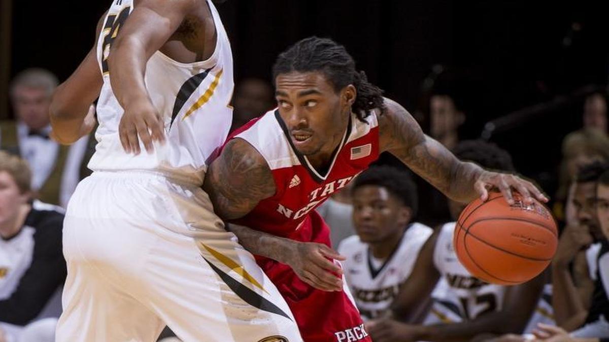 North Carolina State's Anthony Barber, right, dribbles around Missouri's Kevin Puryear, left, during the first half in Columbia, Mo.