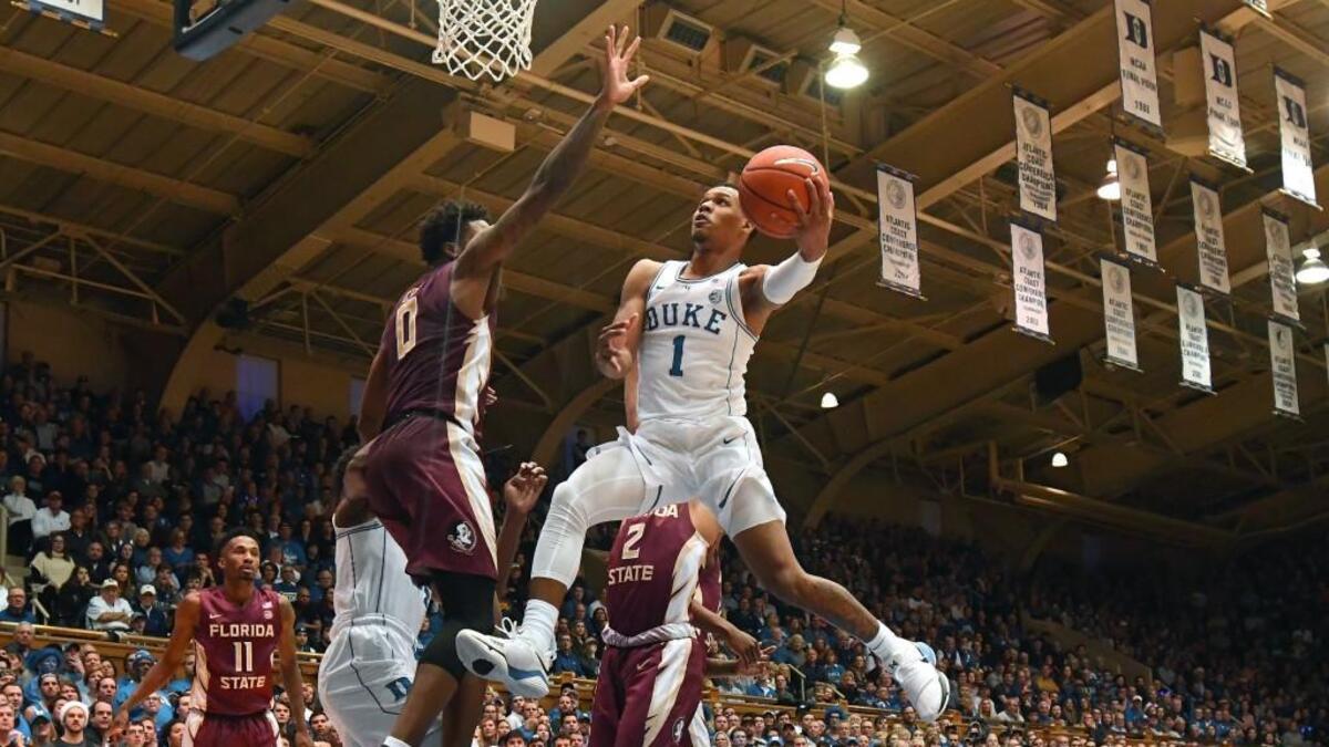 Duke guard Trevon Duval, right, goes in to score against Florida State on Dec. 30.